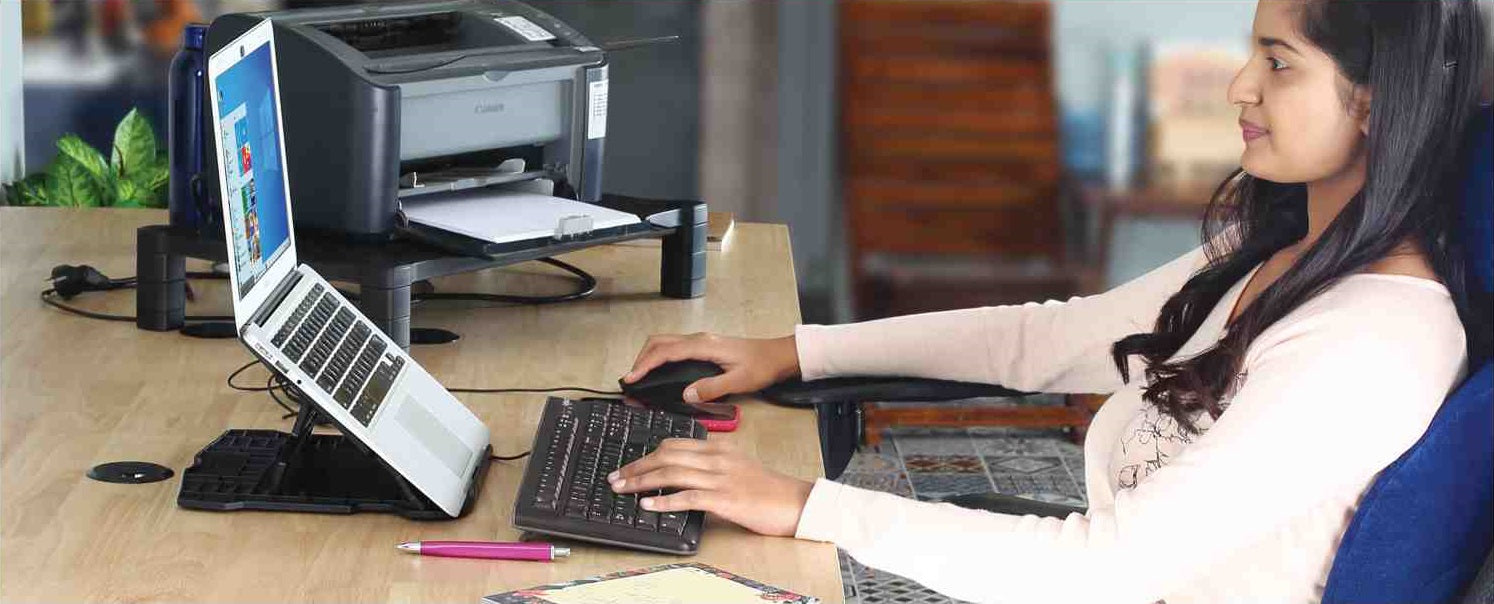 Person using PALO adjustable laptop stand with external keyboard, mouse, and memory foam wrist rest mousepad